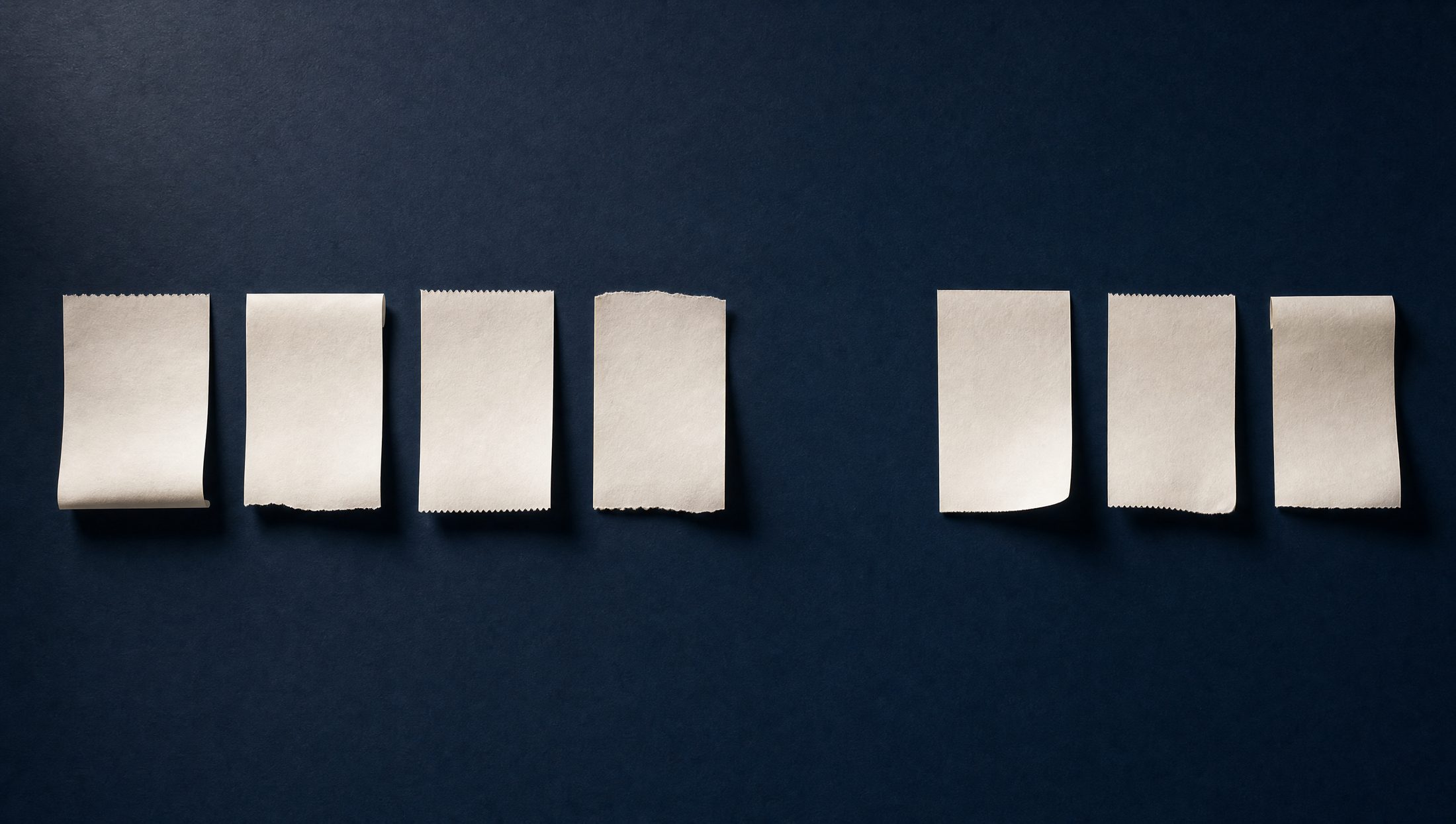 Seven blank paper receipts in a row on a dark navy surface, with one slot conspicuously empty, marked $612.40, no receipt.